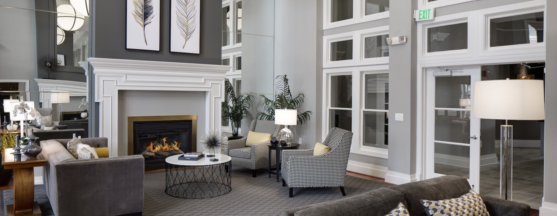 a spacious lounge with high ceilings and a fireplace