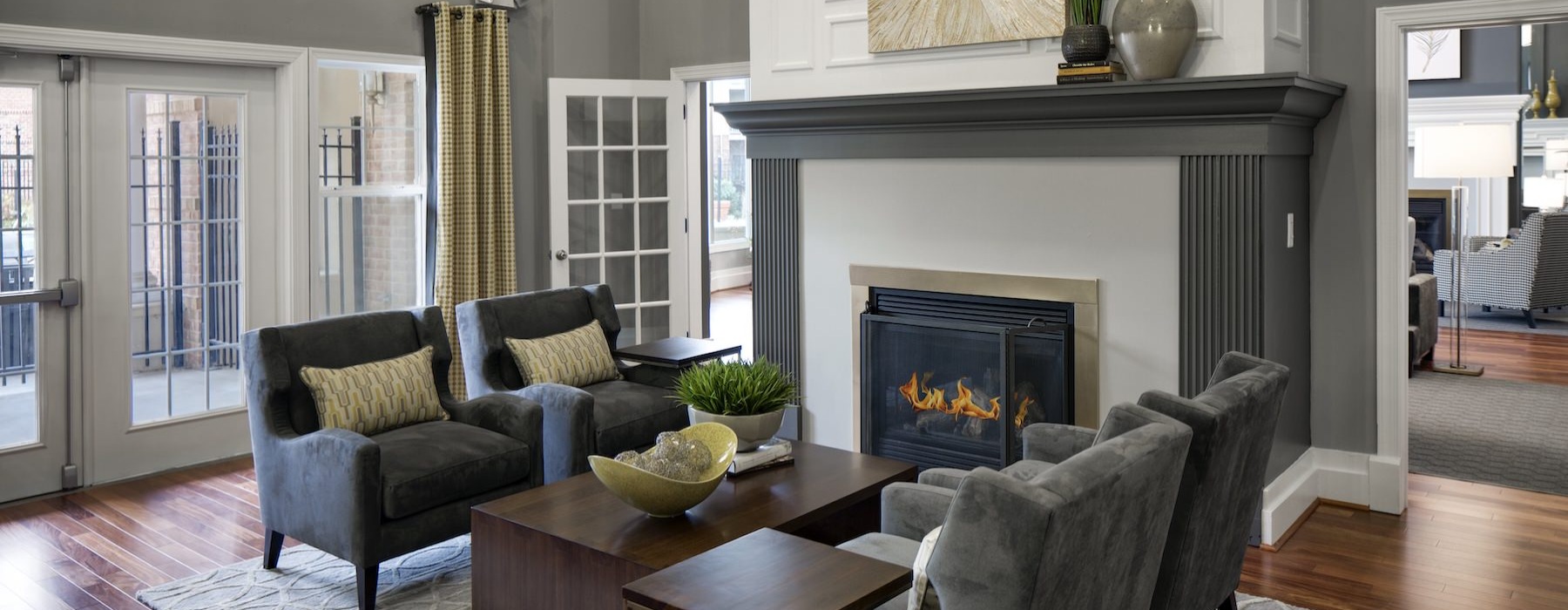 a naturally-lit room with chairs and a fire place