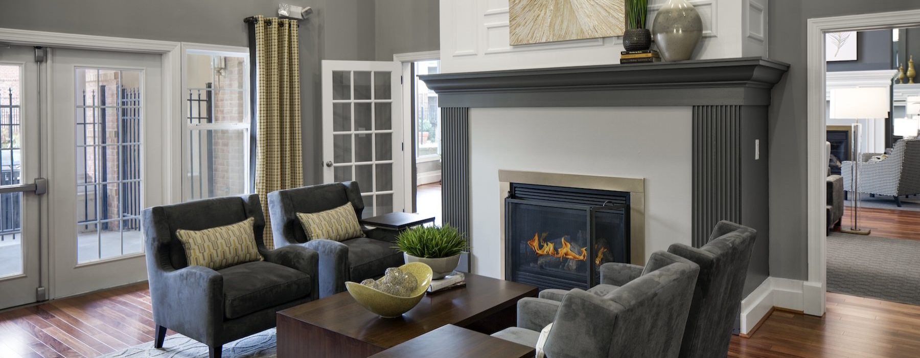 a naturally-lit room with chairs and a fire place