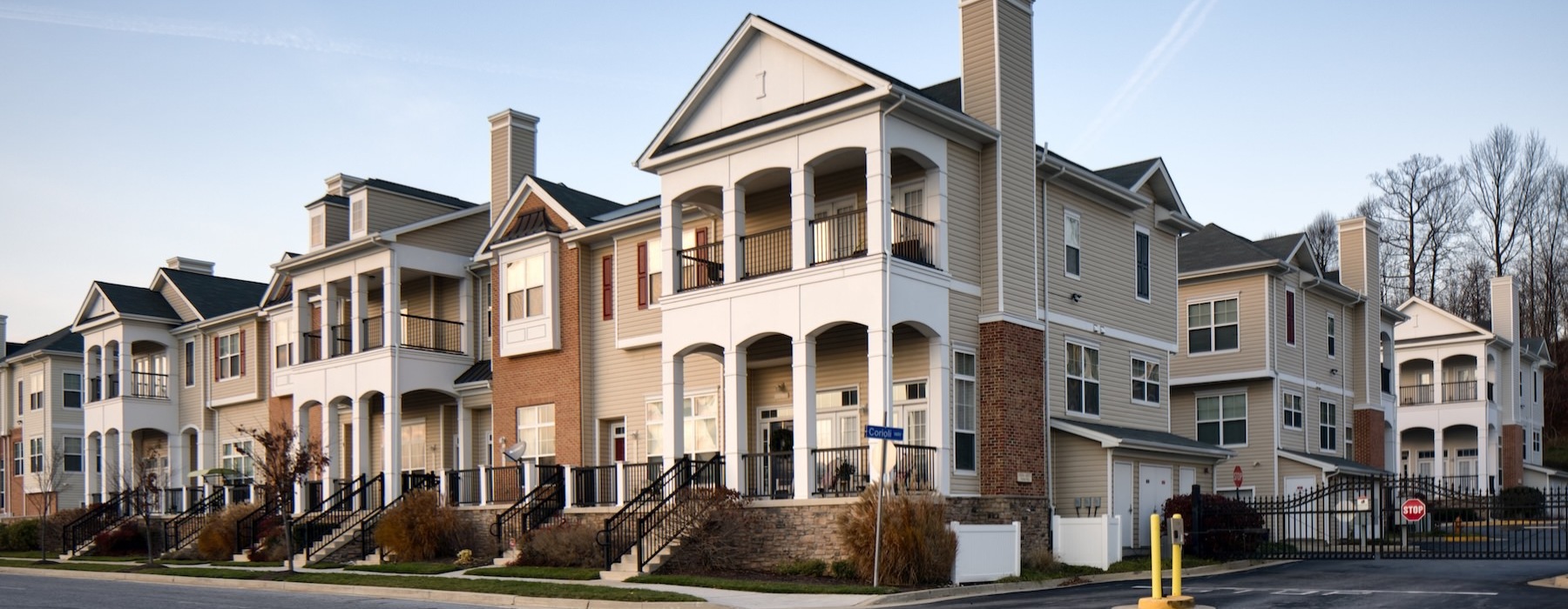 a row of apartment buildings with patios and balconies