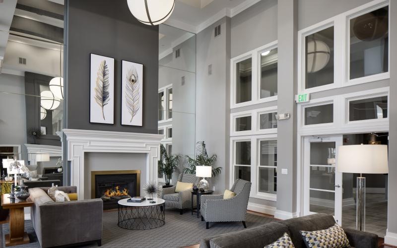a spacious lounge with high ceilings and a fireplace